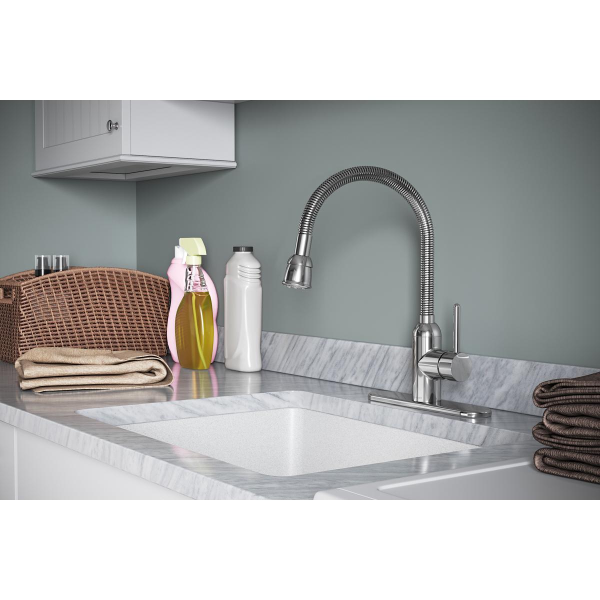 Chrome utility faucet with flexible hose spout and single forward lever handle installed on marble laundry sink.