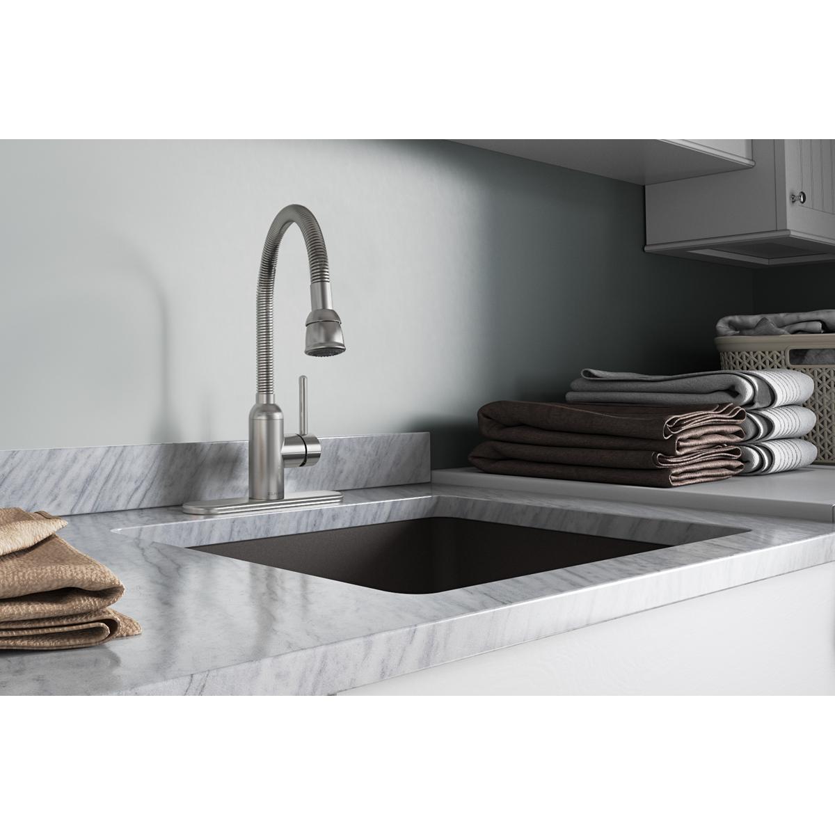 Lustrous steel laundry faucet with flexible spout and forward-only lever handle mounted above marble countertop sink.