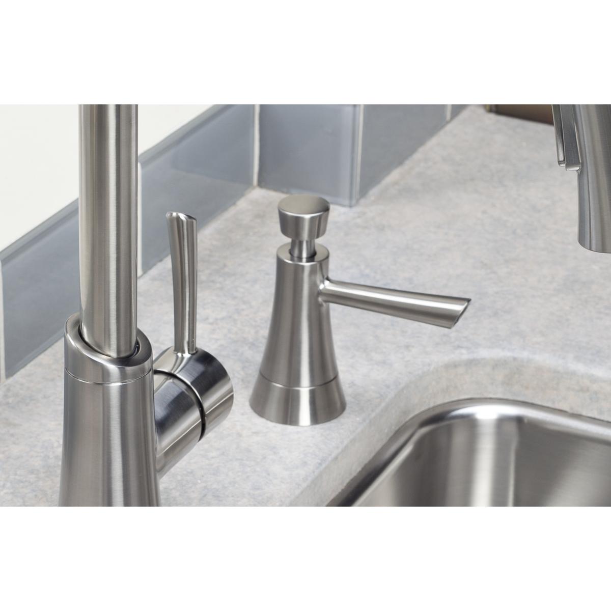 Lustrous steel soap dispenser with conical body and pump top mounted on sink countertop.