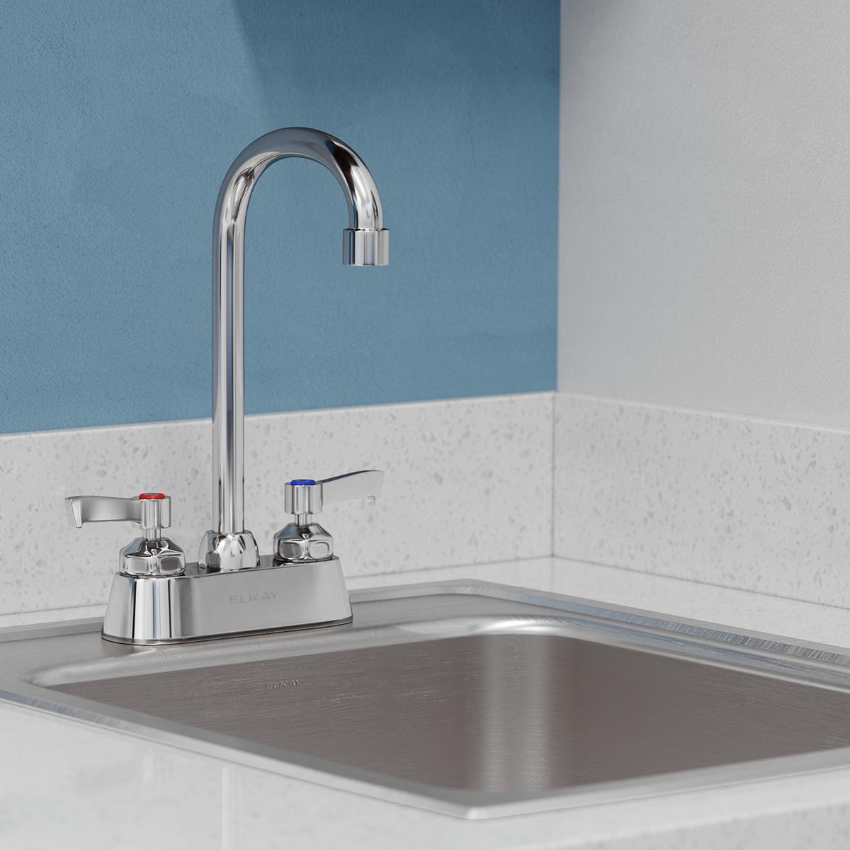 Chrome centerset faucet with gooseneck spout and two lever handles mounted on sink deck.