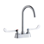 Chrome centerset faucet with curved gooseneck spout and white wristblade handles on white base.