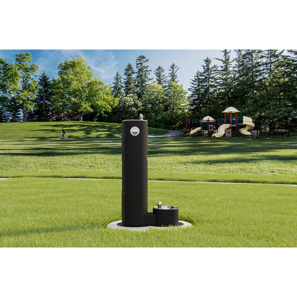 Black pedestal fountain with pet drinking bowl at base, positioned in outdoor grass setting.
