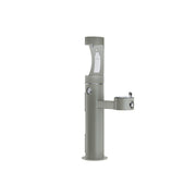 Gray pedestal water filling station with upper bottle filler and lower bowl spout, featuring two foot pedal controls.