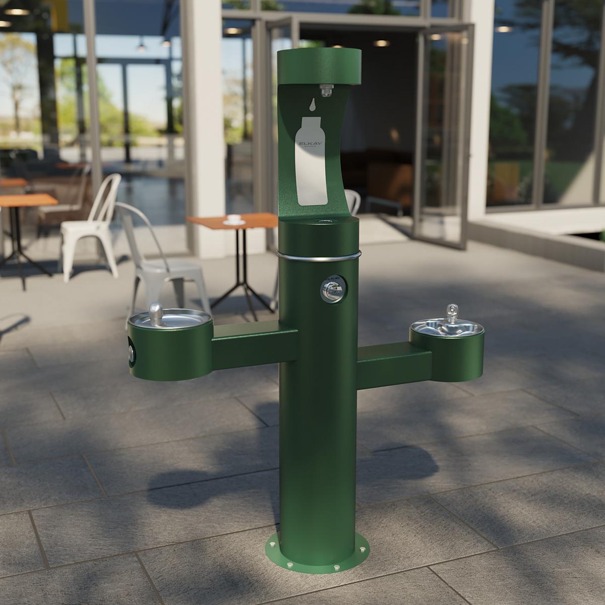 Green pedestal water fountain with three filling stations at different heights and bottle filler spout at top.