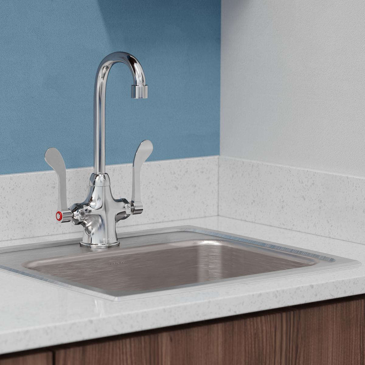 Chrome single-hole kitchen faucet with gooseneck spout and wristblade handles mounted above stainless steel sink.