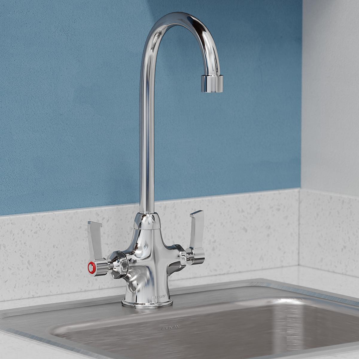 Chrome kitchen faucet with gooseneck spout and two lever handles mounted on countertop above sink.