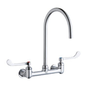 Chrome deck mount faucet with tall gooseneck spout and white wristblade handles.