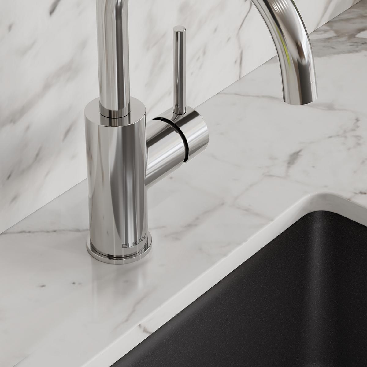 Chrome single-hole bar faucet with tall cylindrical spout and lever handle mounted on marble countertop.