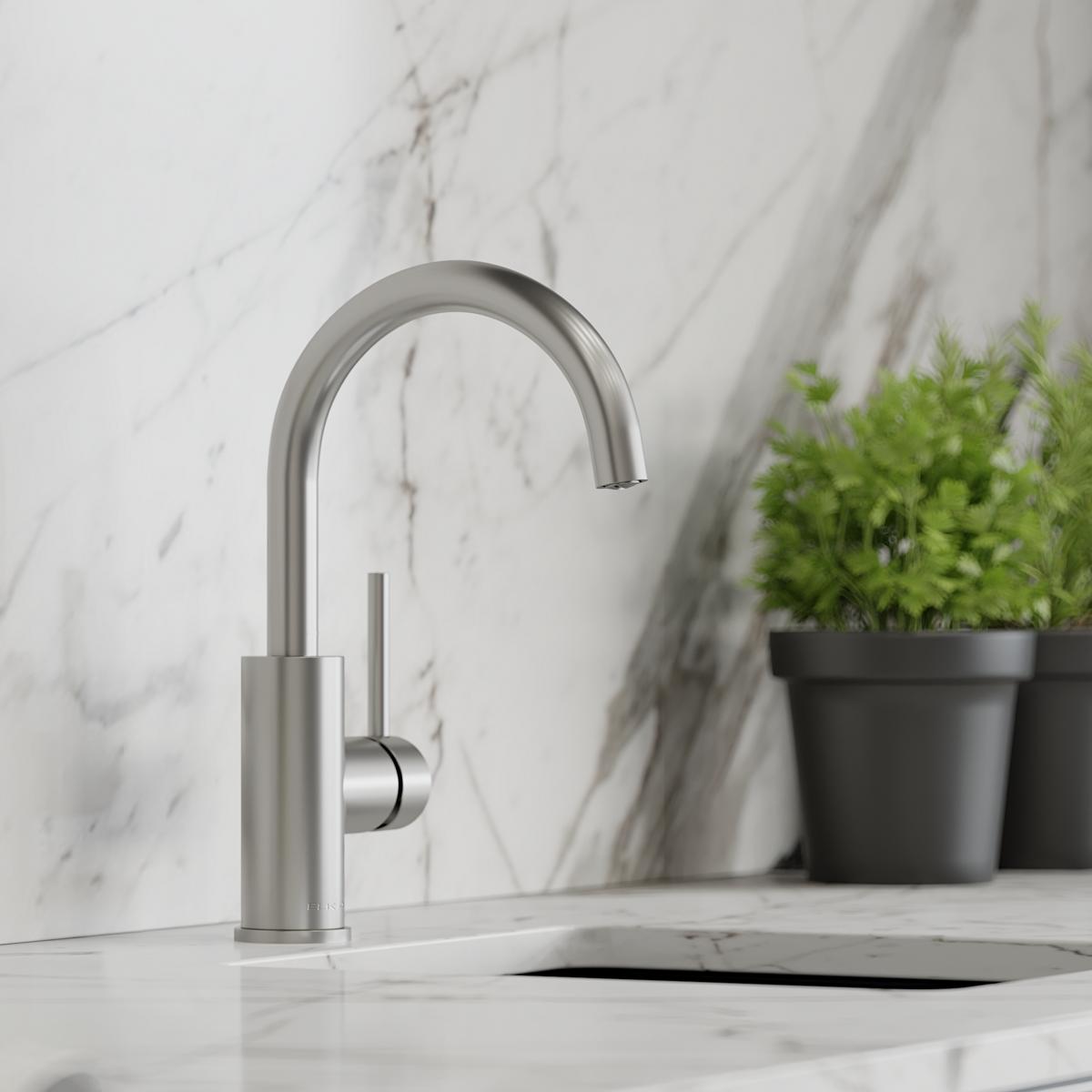 Single hole bar faucet with curved spout and lever handle in lustrous steel finish on marble counter.