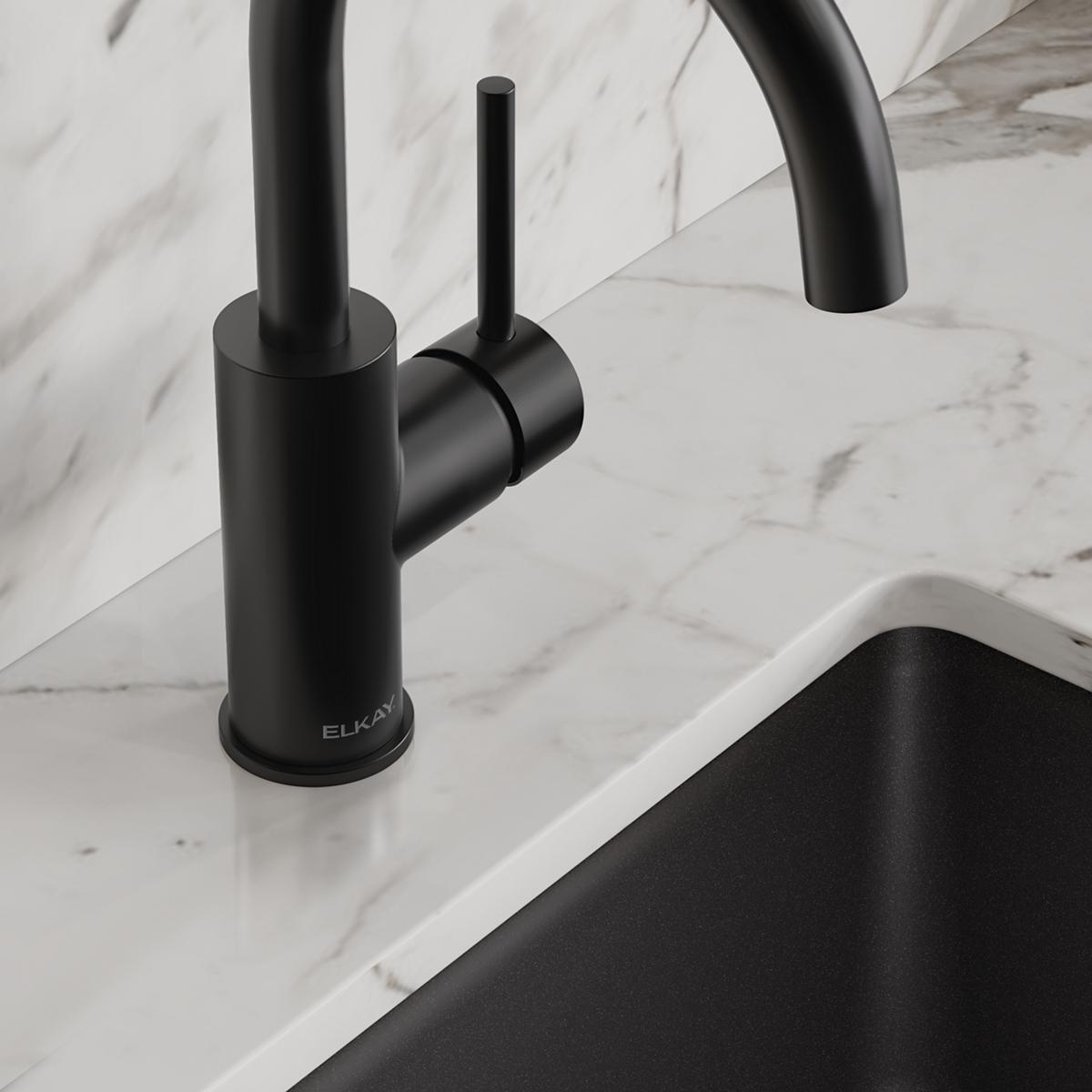 Matte black single-hole bar faucet with lever handle on marble countertop next to black sink.