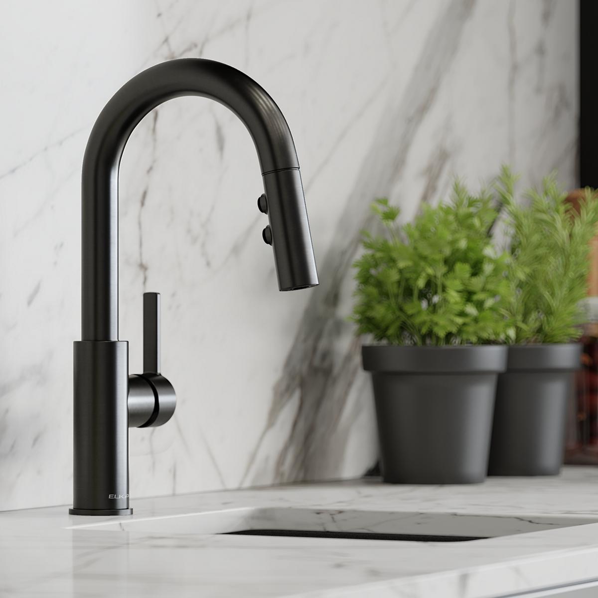 Black stainless steel bar faucet with curved spout, pull-down spray nozzle, and lever handle on marble countertop.
