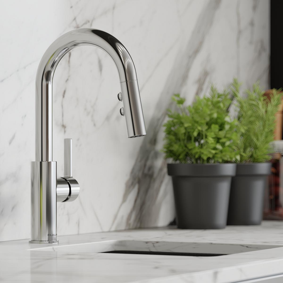 Chrome single-hole bar faucet with pull-down spray head and lever handle on marble countertop.