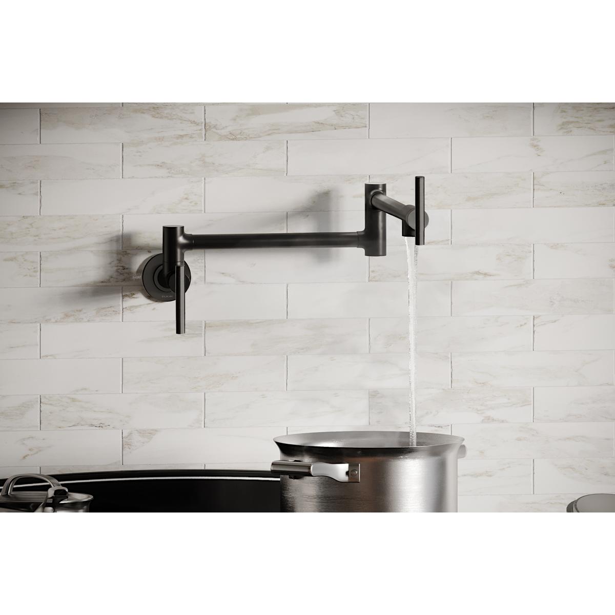 Black stainless steel wall-mounted pot filler faucet with lever handles mounted above a stainless steel pot.