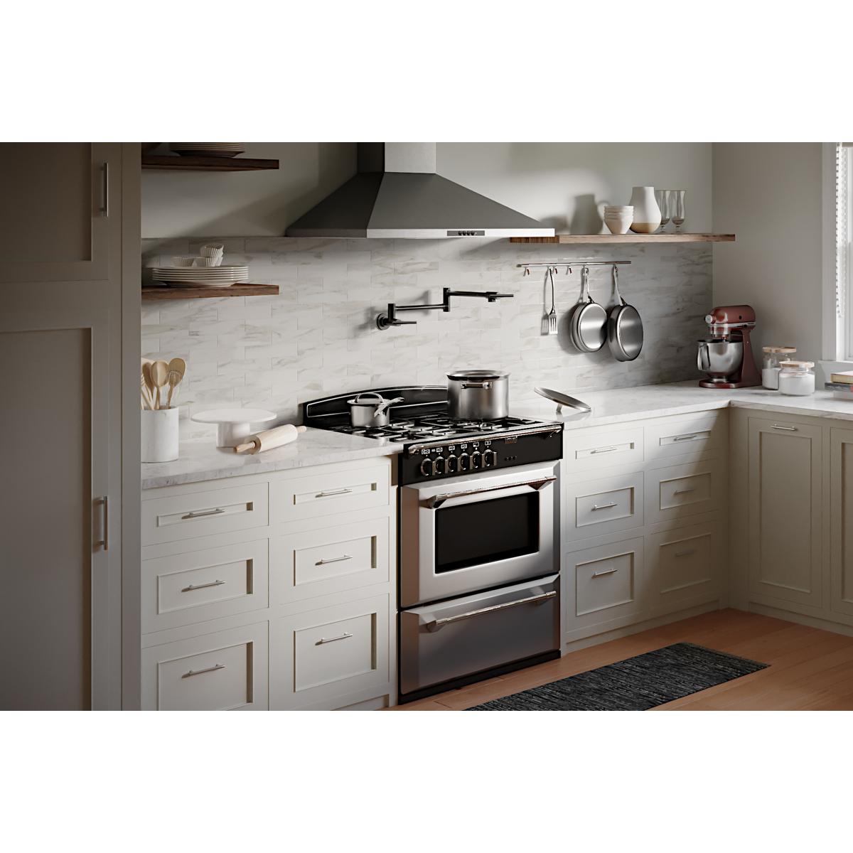 Black stainless steel wall-mounted pot filler faucet with lever handles installed above a kitchen stovetop.