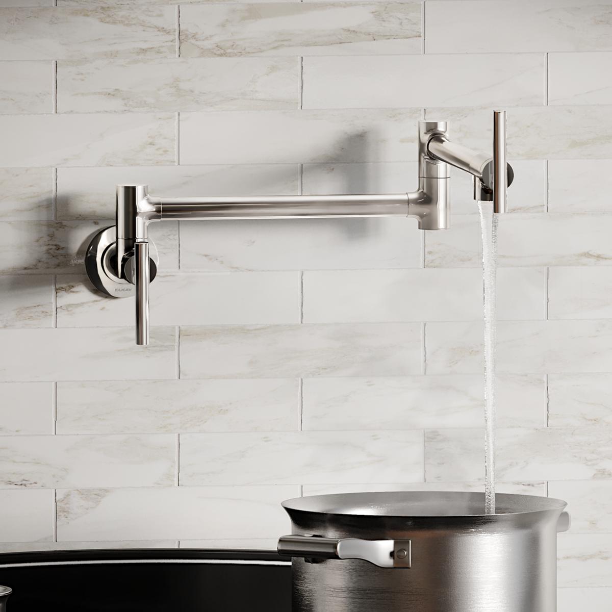 Chrome wall-mounted pot filler faucet with articulating arm and lever handle filling a stainless steel pot.