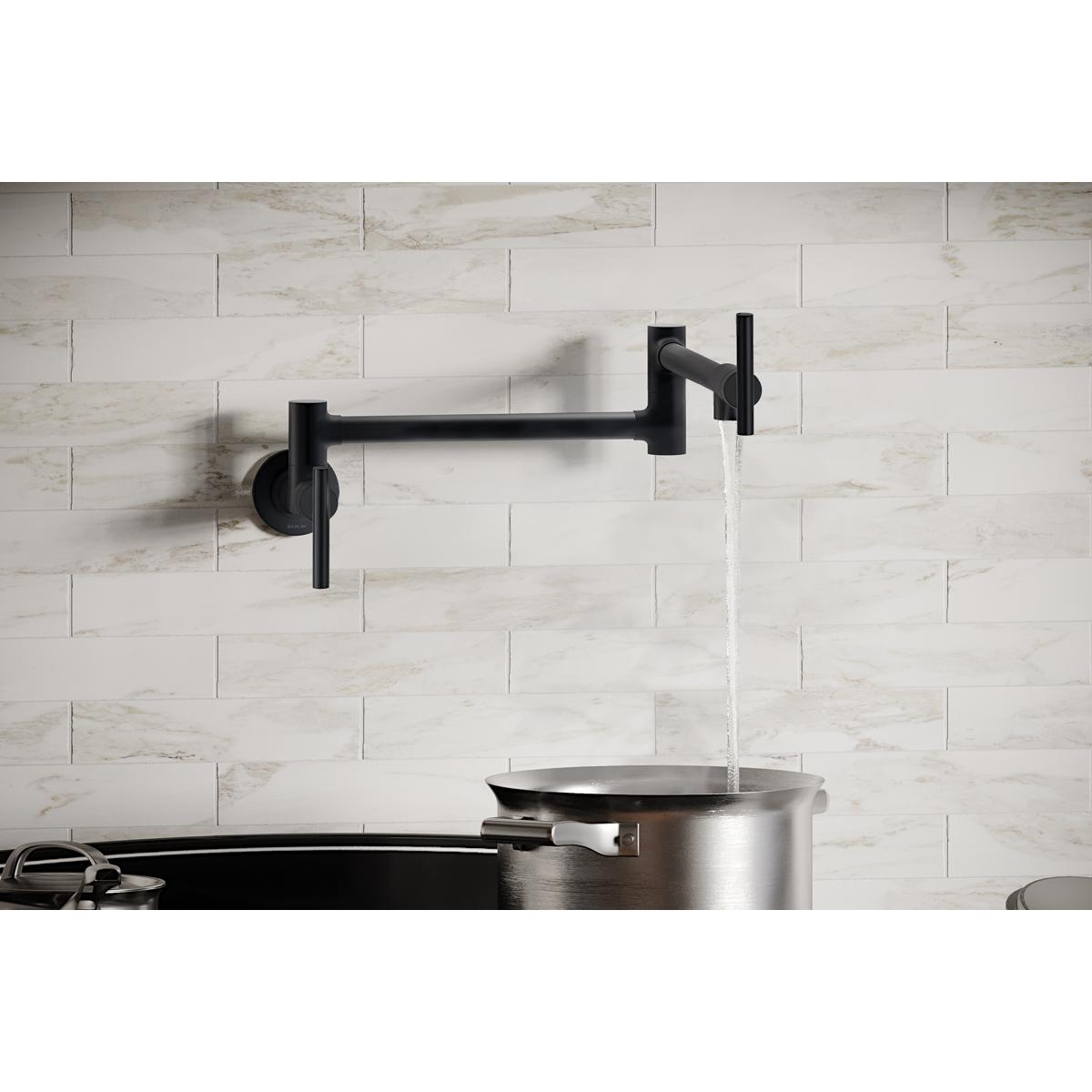 Matte black wall-mounted pot filler faucet with lever handles and articulating arm, water flowing into stainless steel pot.