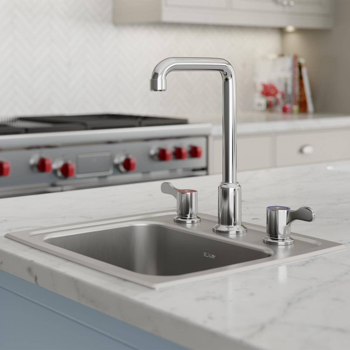 Stainless steel drop-in bar sink with single bowl, three-hole faucet mounting, and chrome faucet with lever handles installed