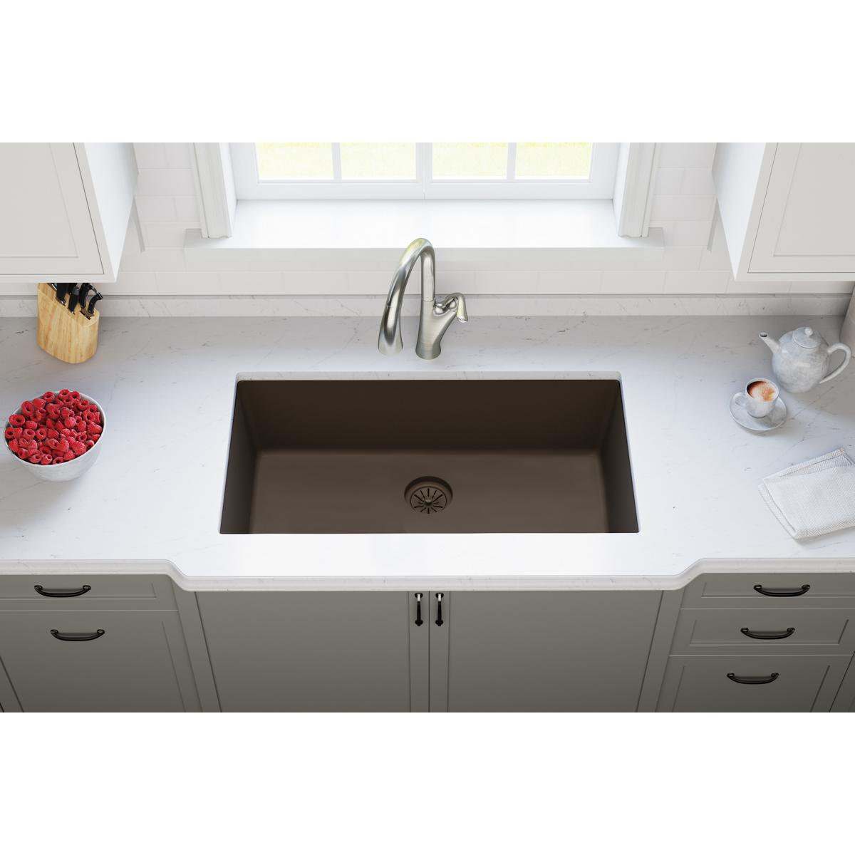 Chestnut polymer sink drain flange with basket strainer visible at bottom of undermount kitchen sink.