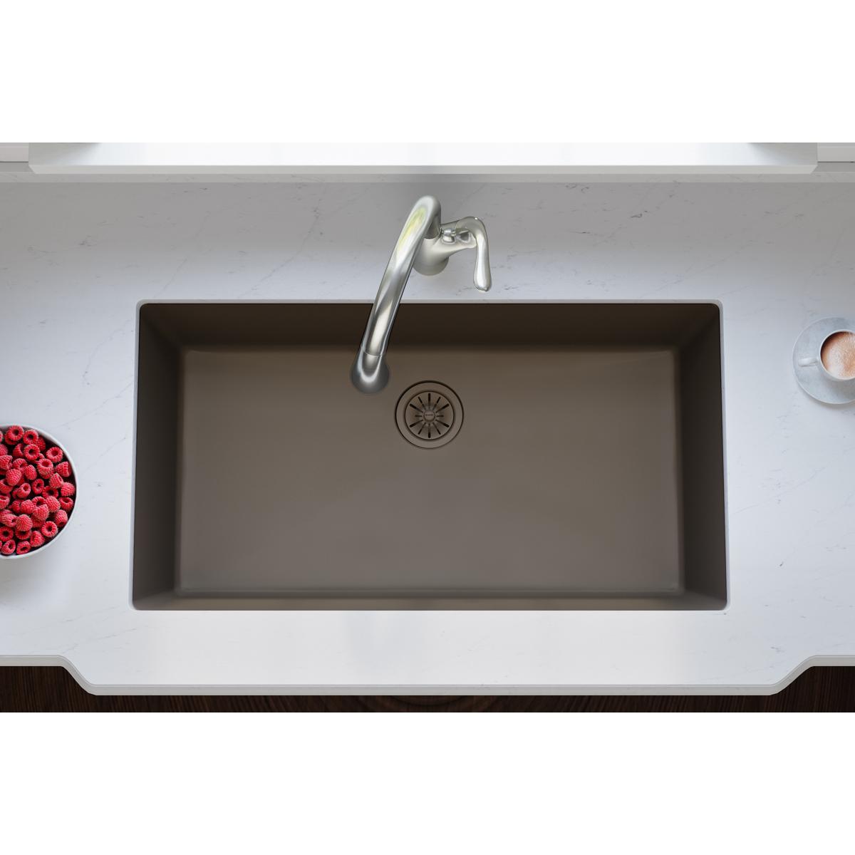 Chestnut polymer kitchen sink with drain flange and basket strainer visible in center.