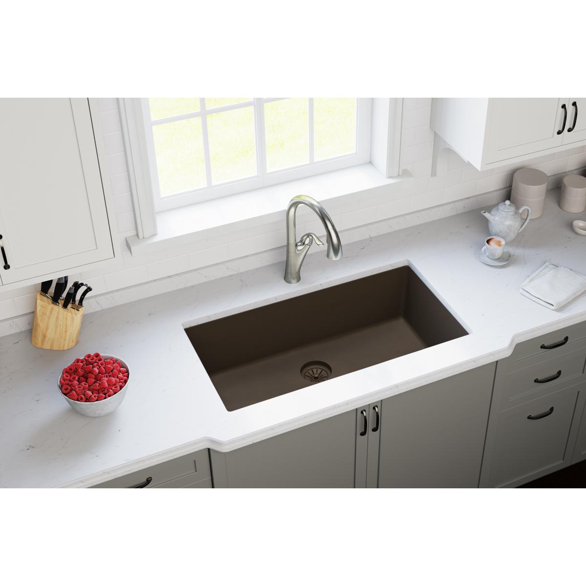 Chestnut polymer sink drain flange with basket strainer installed in undermount kitchen sink.