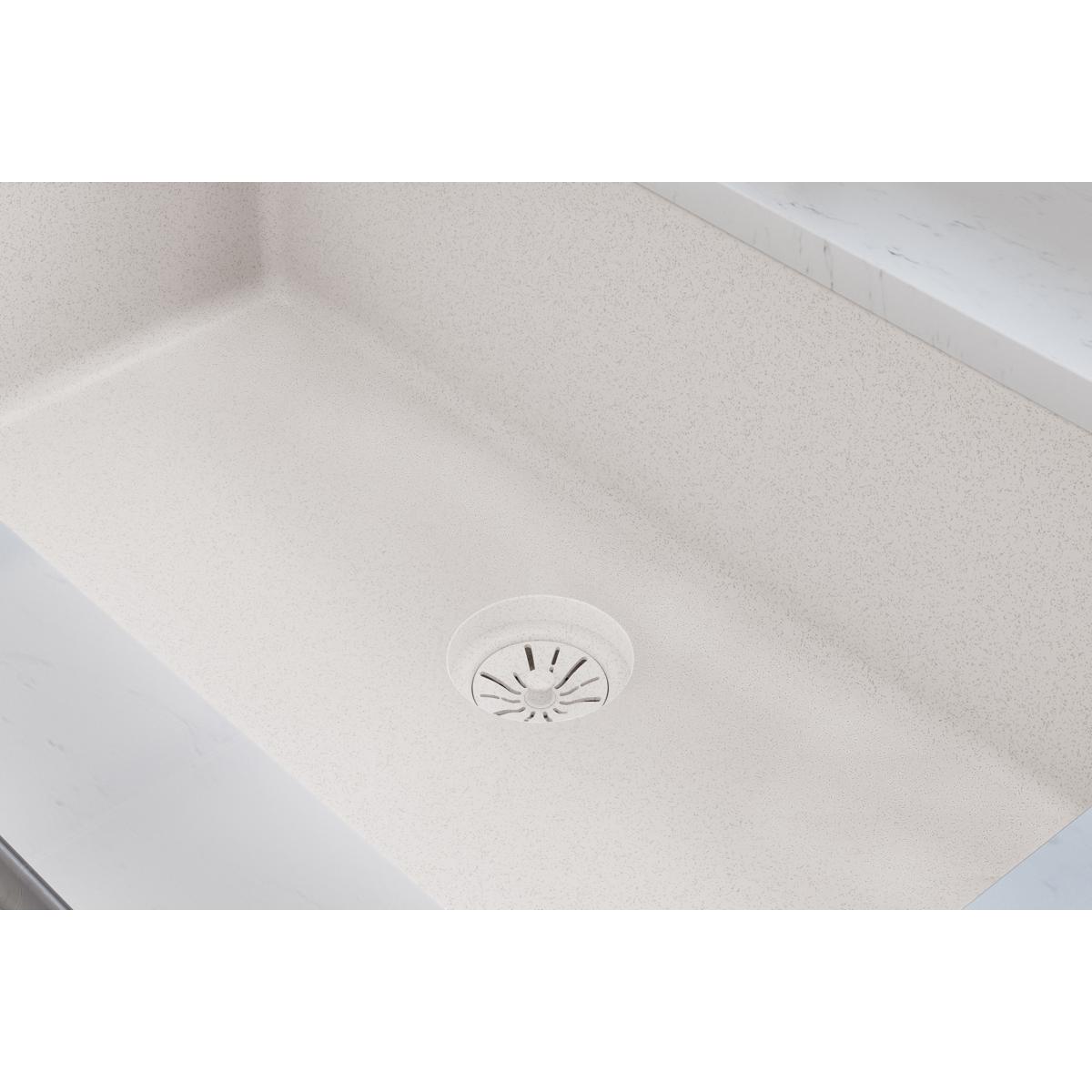 Polymer disposer flange with basket strainer installed in light-colored quartz sink basin.