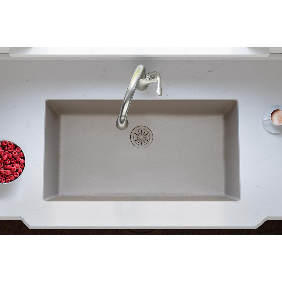 Silvermist quartz sink basin with chrome faucet and circular drain strainer visible from above.