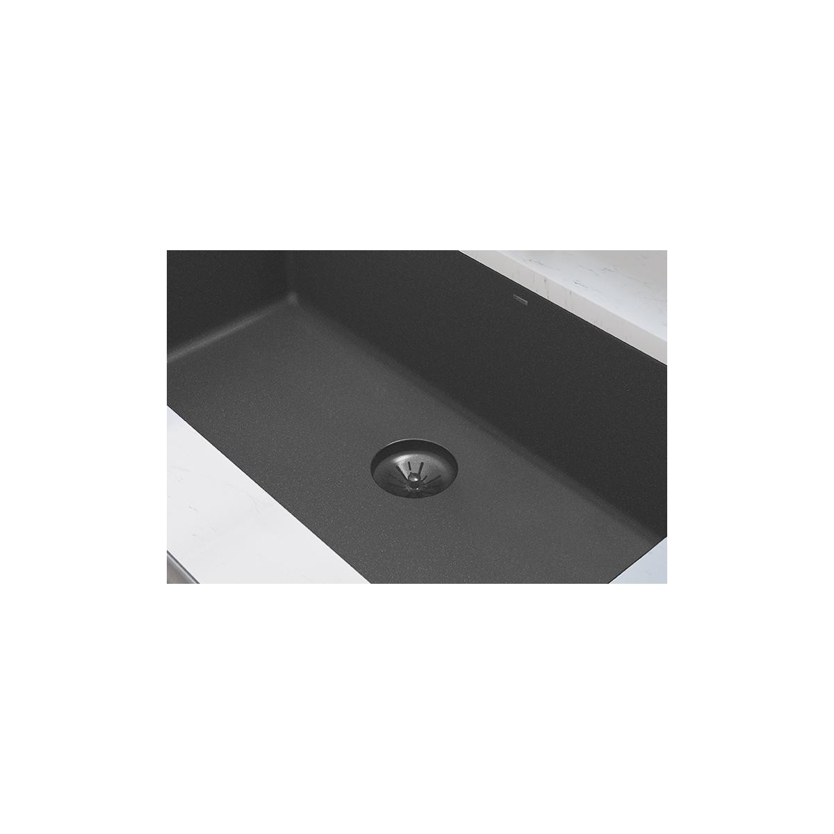 Charcoal basket strainer with rubber stopper installed in sink drain opening.