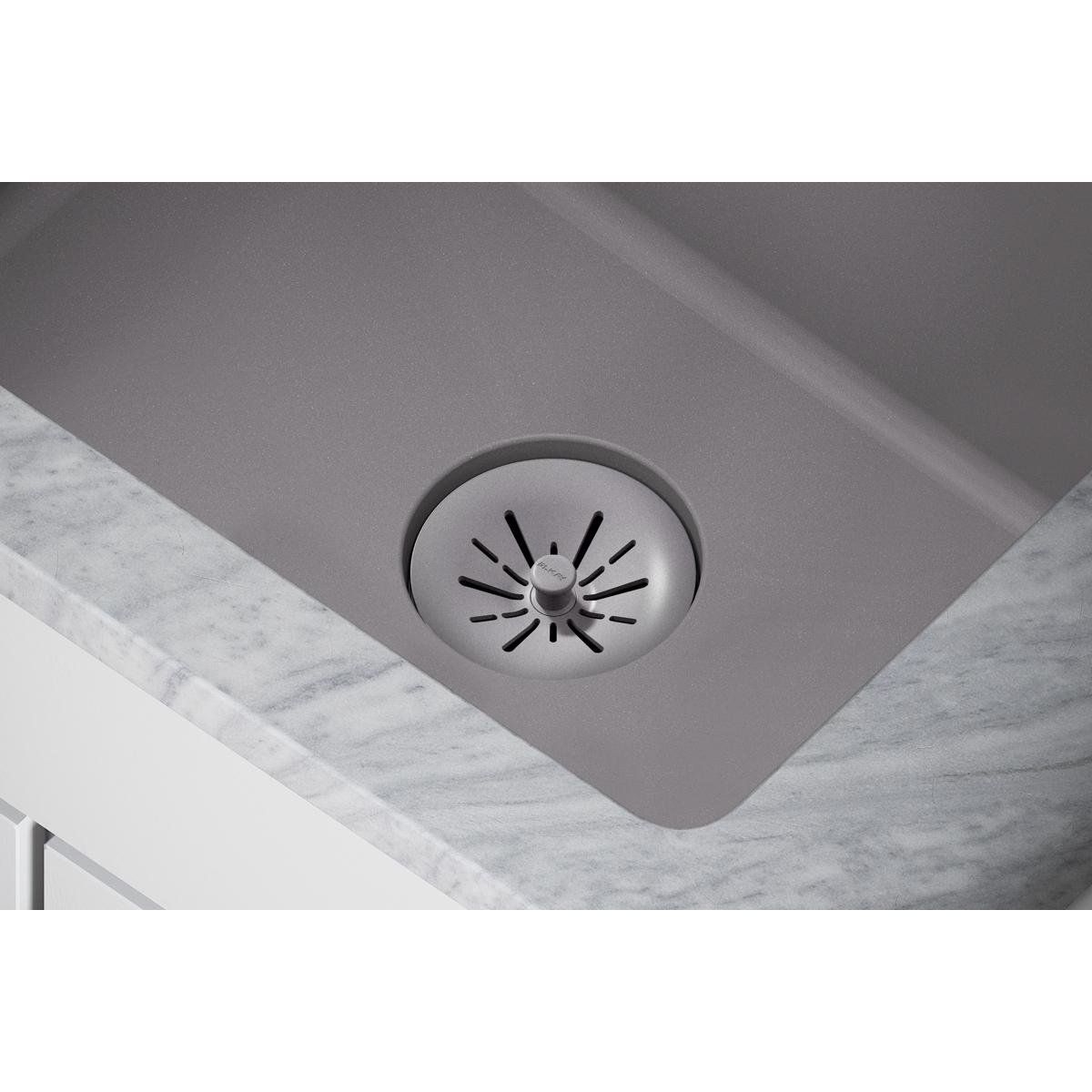 Greystone polymer basket strainer with slotted drain opening installed in sink basin.