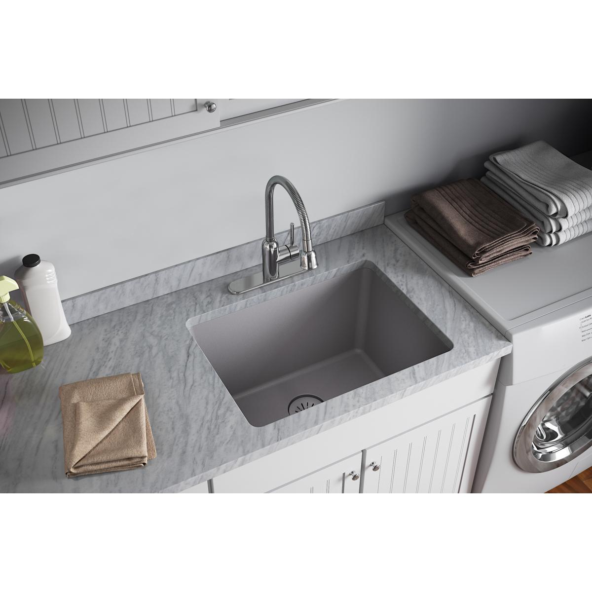 Greystone quartz sink with removable polymer basket strainer and rubber stopper drain visible in basin.