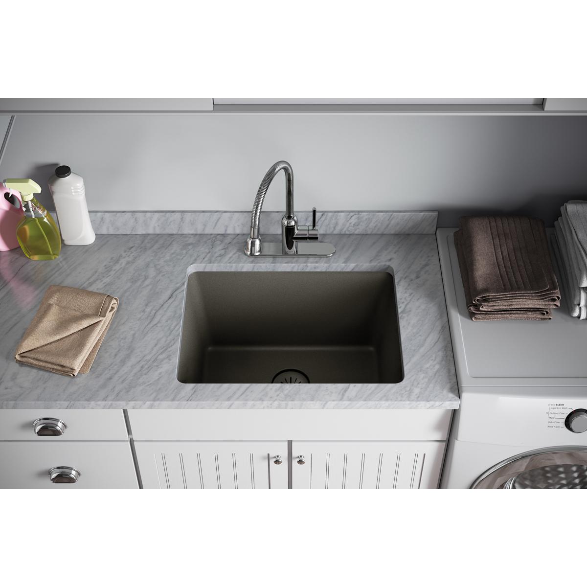 Dusk gray quartz sink with removable polymer basket strainer and rubber stopper installed in kitchen countertop.