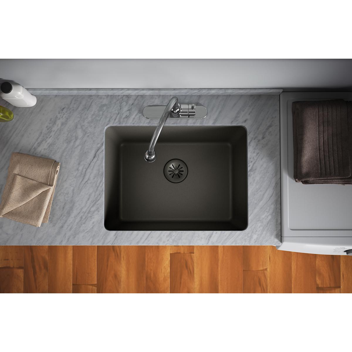Dusk gray quartz sink with removable polymer basket strainer and rubber stopper visible in drain center.