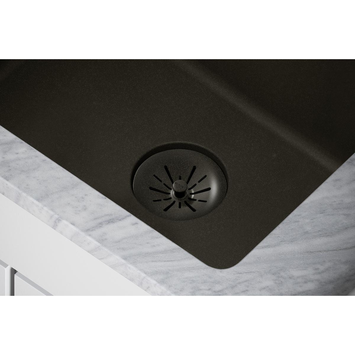 Dusk gray polymer basket strainer with radial slots and central post in sink drain opening.