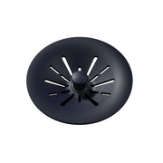 Black polymer basket strainer with radial slots and central knob for sink drain.