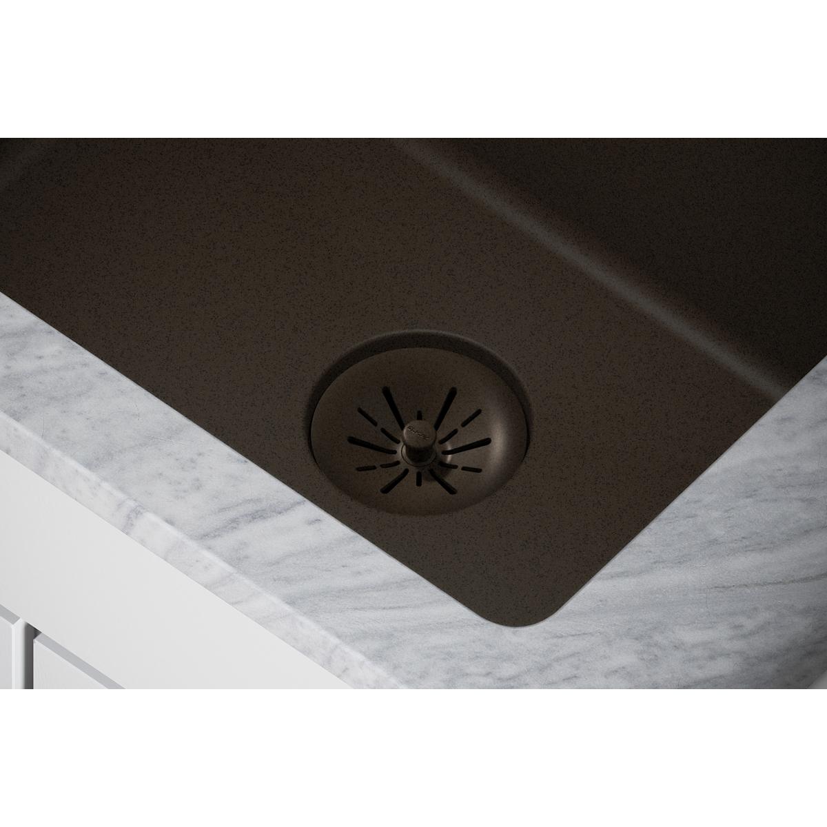 Mocha-colored quartz sink drain with removable polymer basket strainer featuring radial slot design.