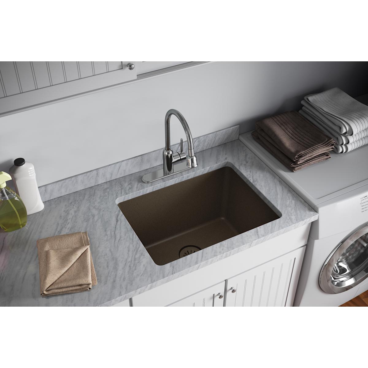 Mocha quartz undermount sink with removable polymer basket strainer and rubber stopper installed in countertop.