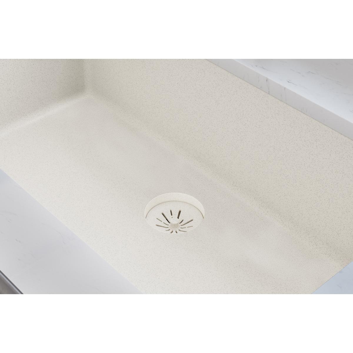 Parchment-colored quartz sink with removable polymer basket strainer featuring radial slots and rubber stopper installed in d