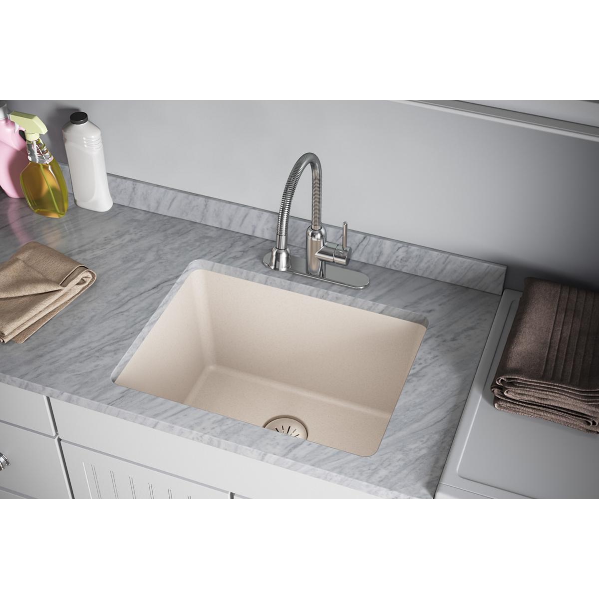 Cream-colored rectangular undermount sink with drain strainer visible at bottom, installed in marble countertop with faucet.