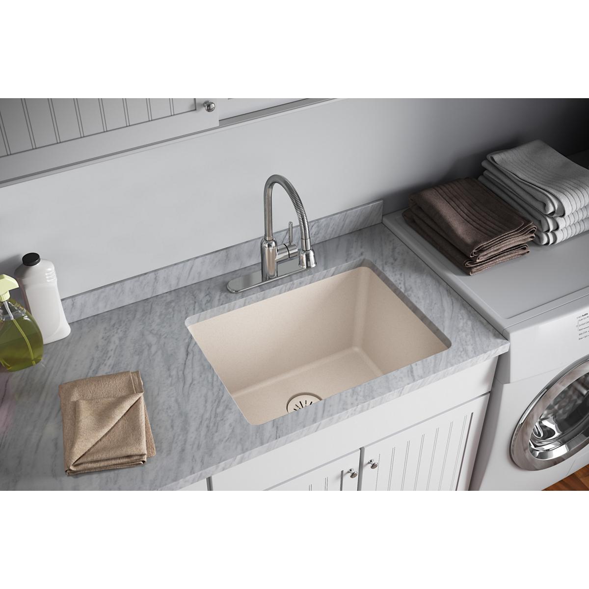 Cream-colored quartz sink basin with metal drain strainer visible at bottom center of sink bowl.