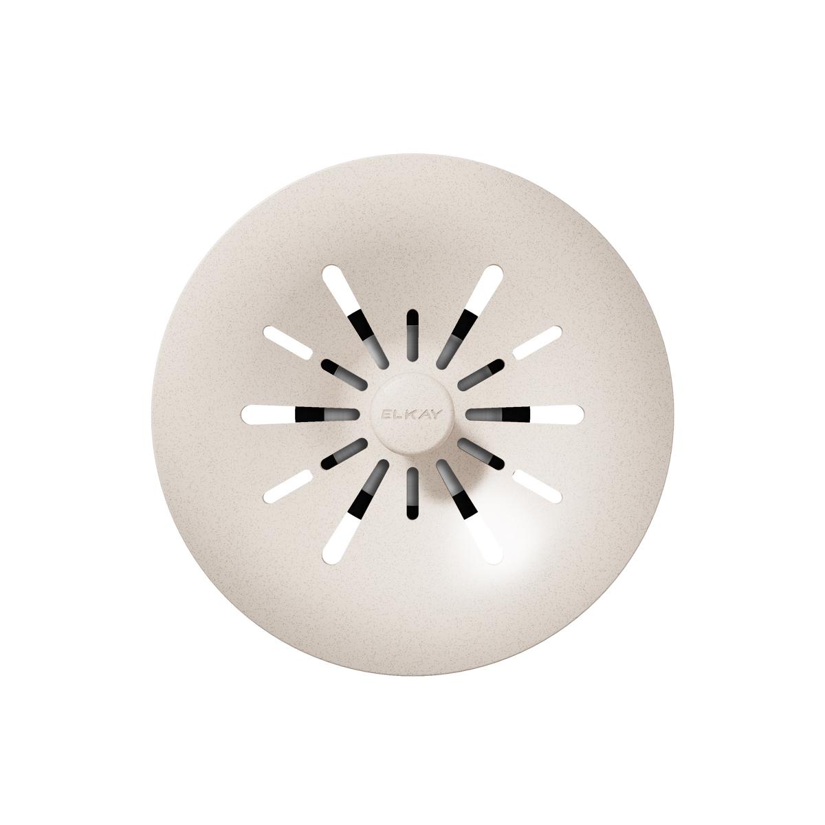 Cream-colored polymer basket strainer with radiating white and black slots and center knob labeled Elkay.