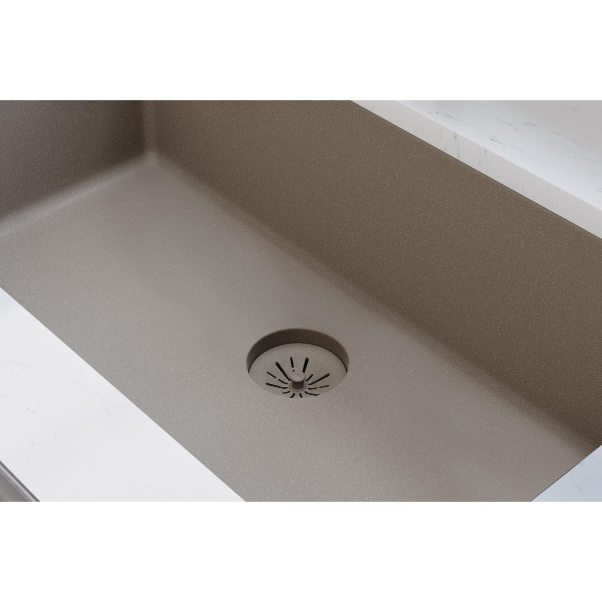 Silvermist quartz sink drain with removable polymer basket strainer and radiating slot pattern.