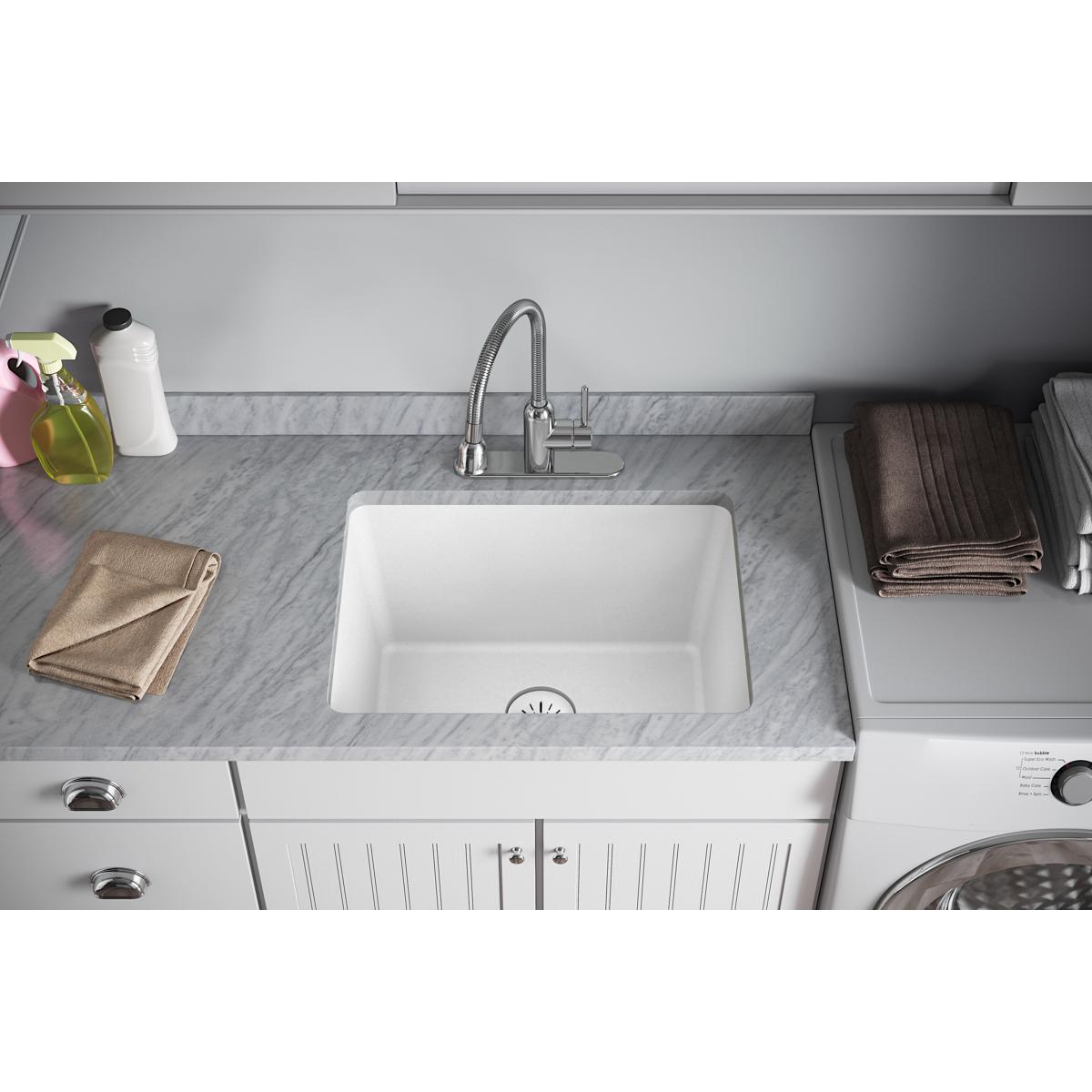 White rectangular sink basin with drain strainer visible at the bottom center, installed in gray countertop.
