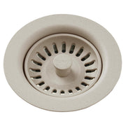 Beige polymer drain fitting with removable basket strainer and central stopper knob.