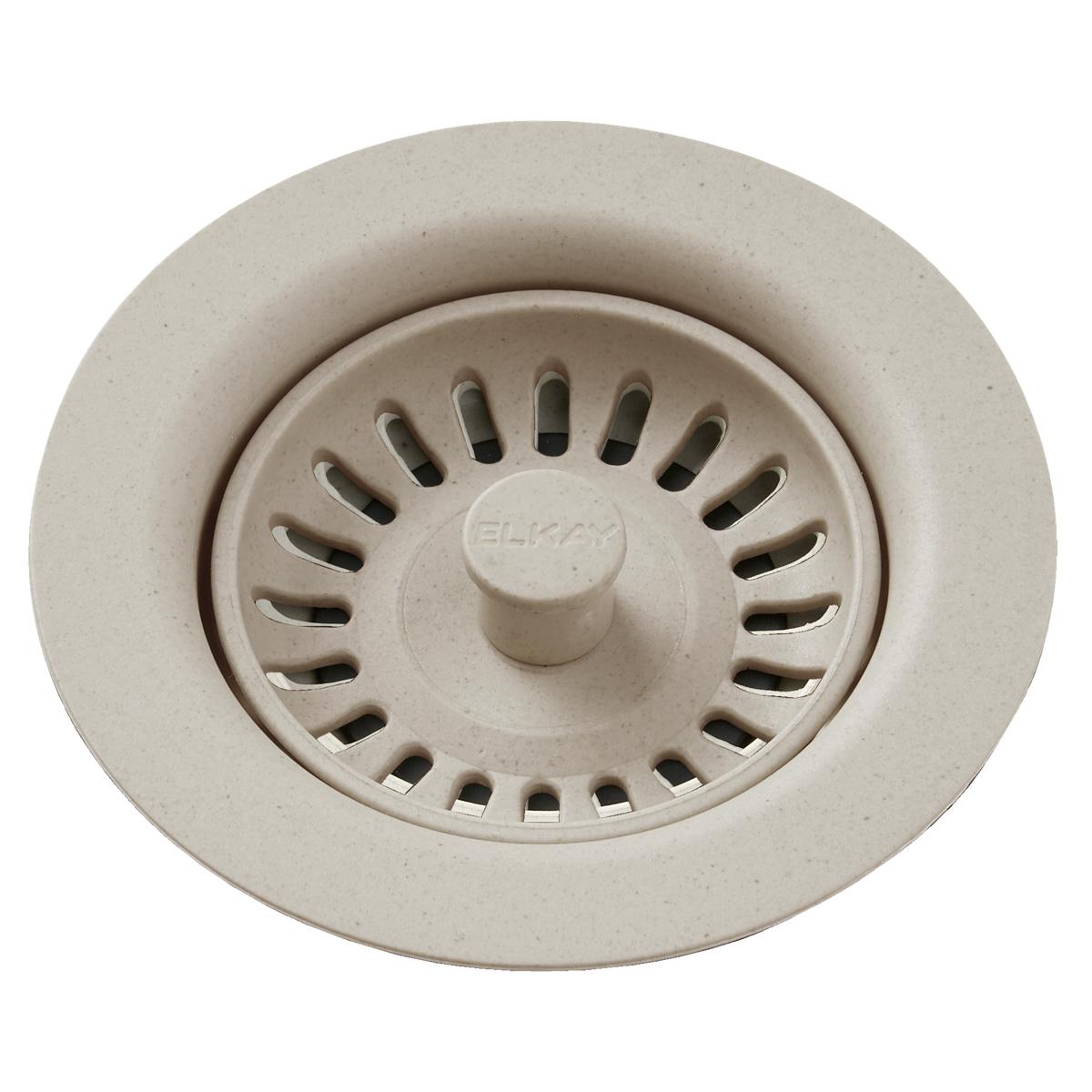 Beige polymer drain fitting with removable basket strainer and central stopper knob.