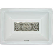 Rectangular white ceramic sink basin with ornate filigree brass grate insert in center.
