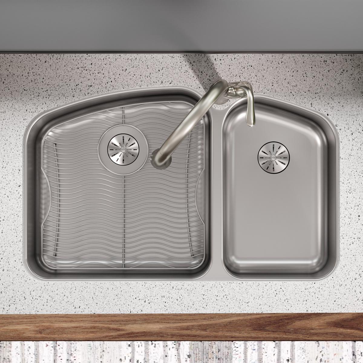 Stainless steel sink bottom grid with wavy ridged pattern and circular drain, measuring 17" x 17-1/2".