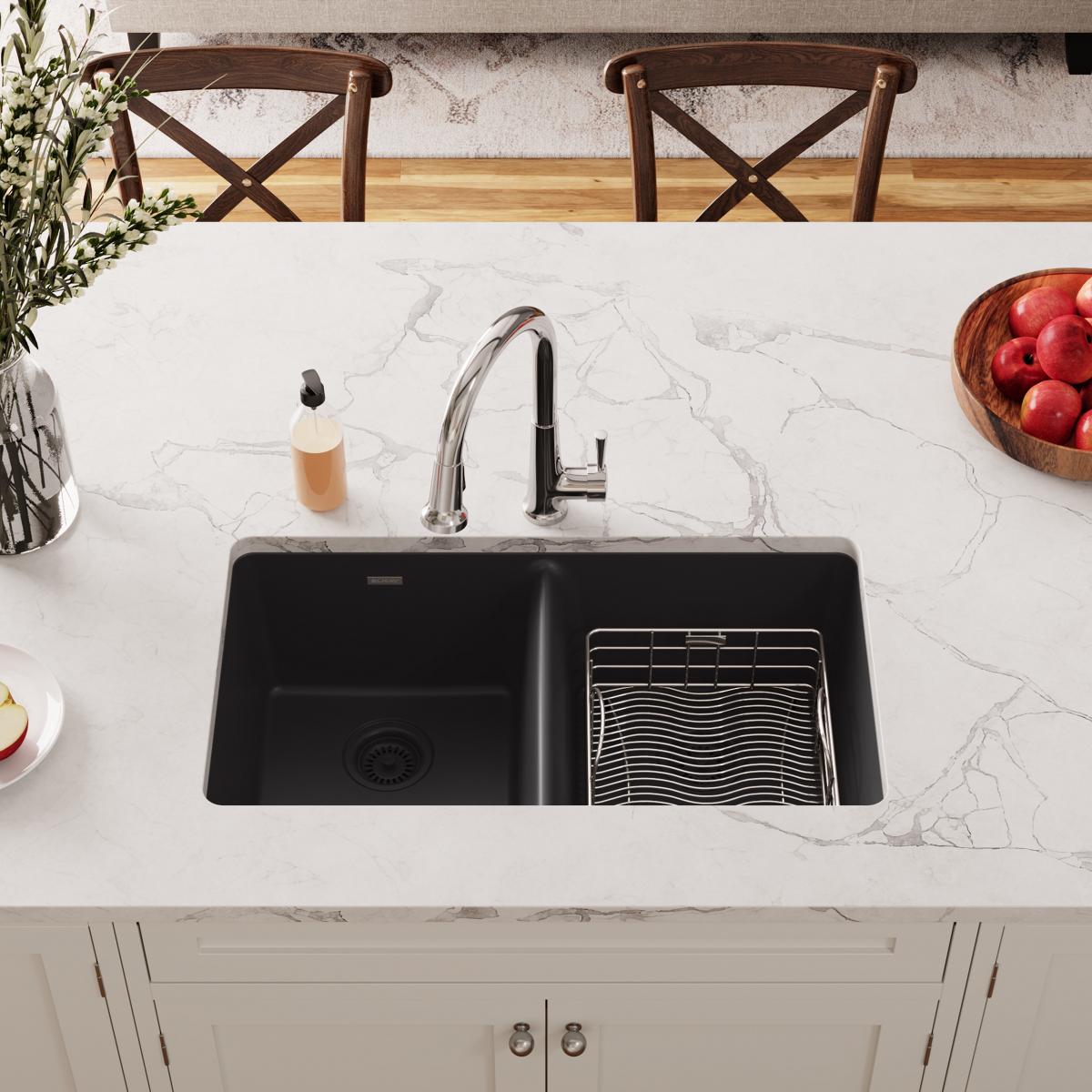 Stainless steel rinsing basket in black double kitchen sink with faucet.