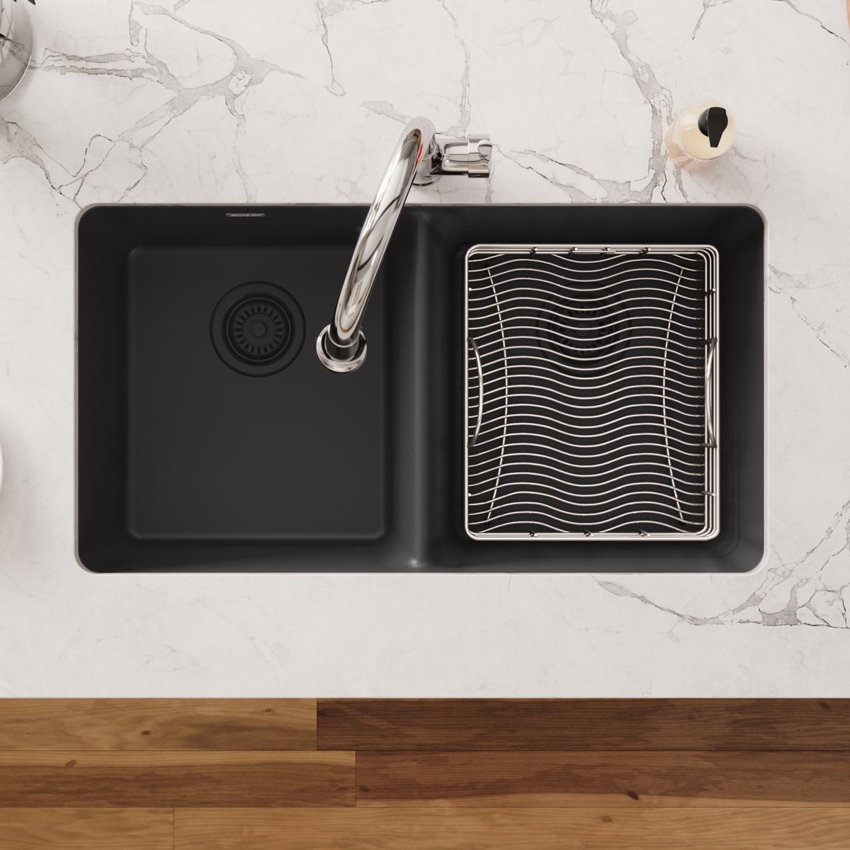 Stainless steel rinsing basket with wavy grid pattern, installed in right compartment of black double sink.
