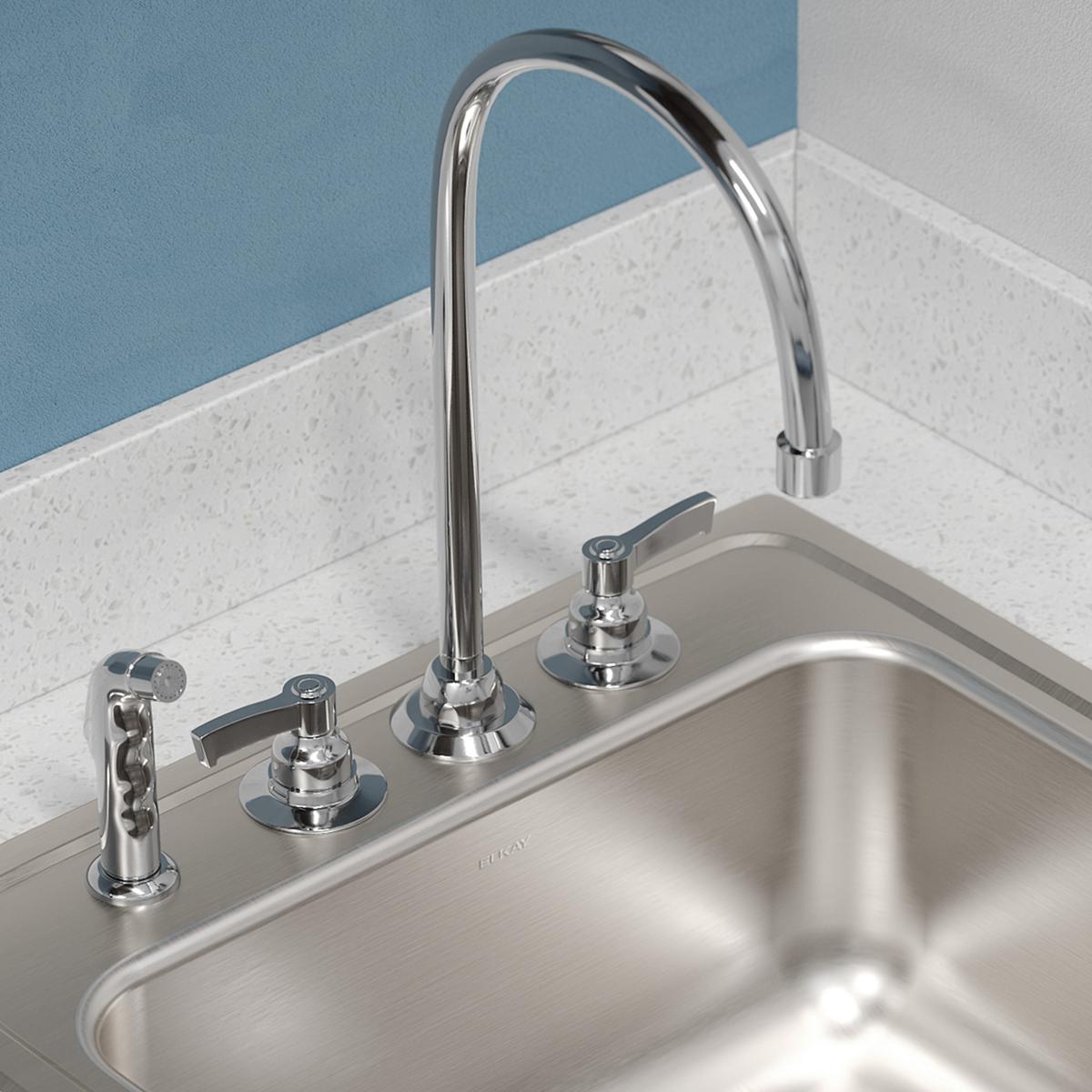 Stainless steel single bowl drop-in sink with polished chrome faucet and four mounting holes on a white countertop.