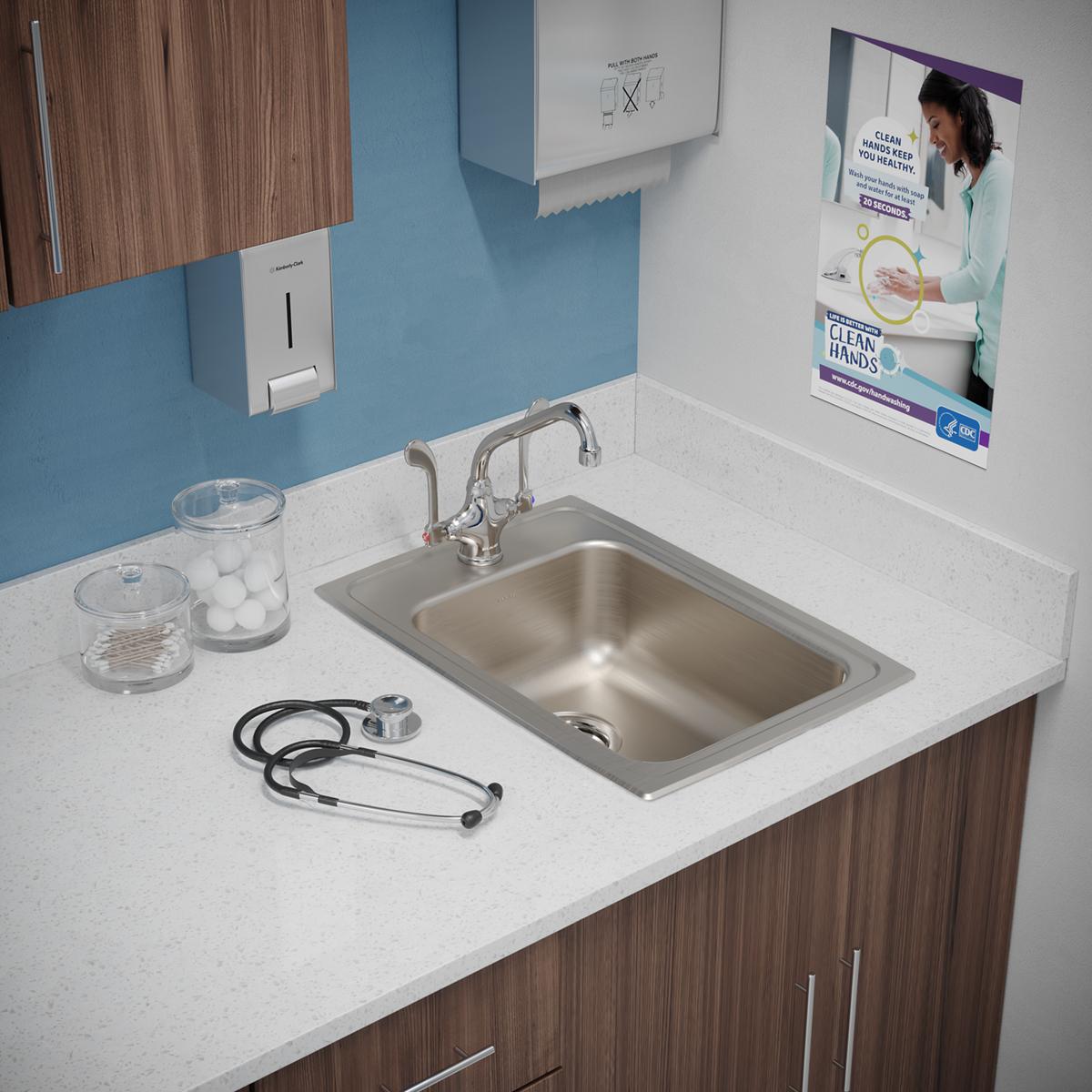 Stainless steel rectangular drop-in sink with single bowl and one faucet hole, installed in white countertop with chrome fauc