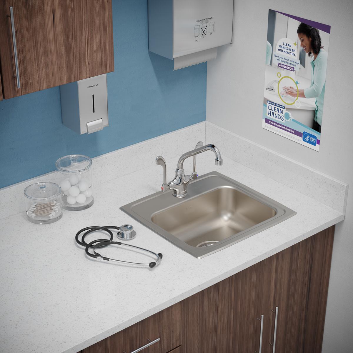 Stainless steel drop-in sink with single bowl and one faucet hole, installed in white countertop with chrome faucet.